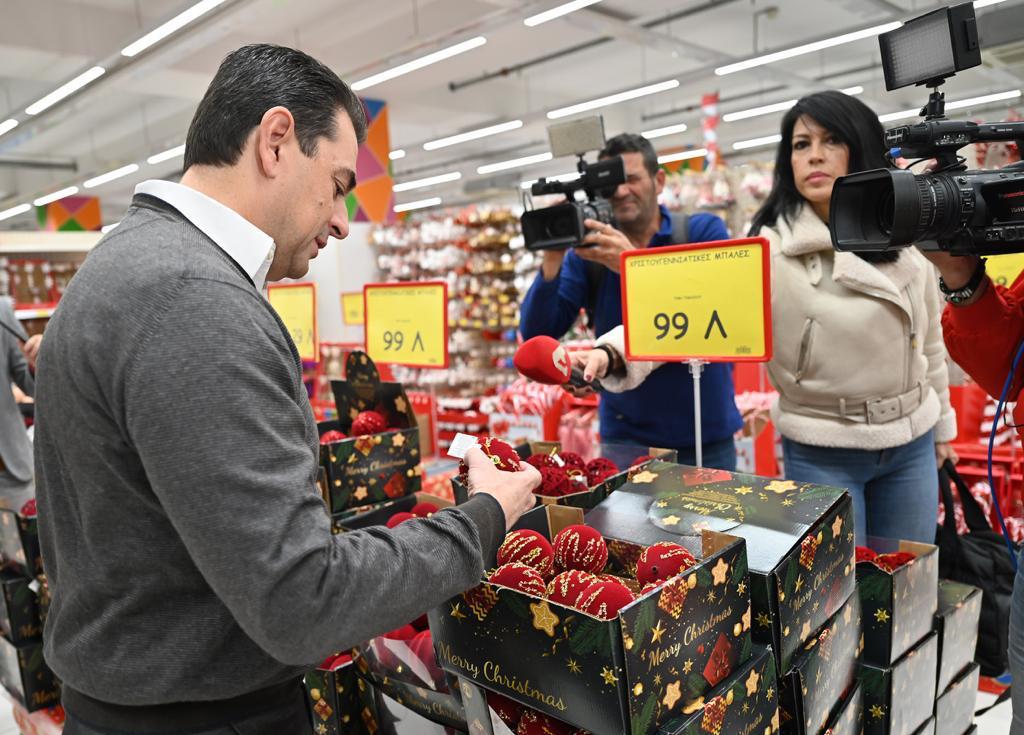 a man holding a camera and a box of strawberries